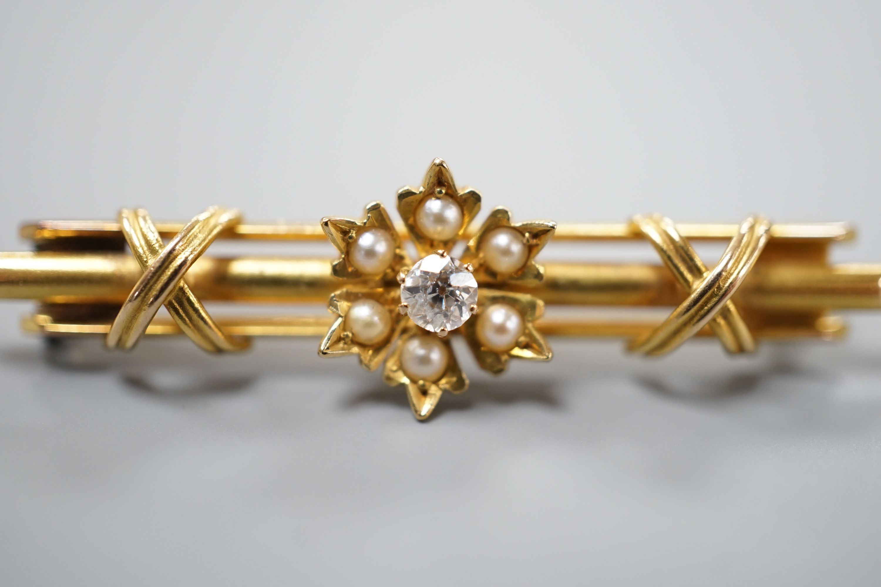 A Victorian 15ct, diamond and seed pearl set flower head bar brooch, 44mm, gross weight 4.3 grams.